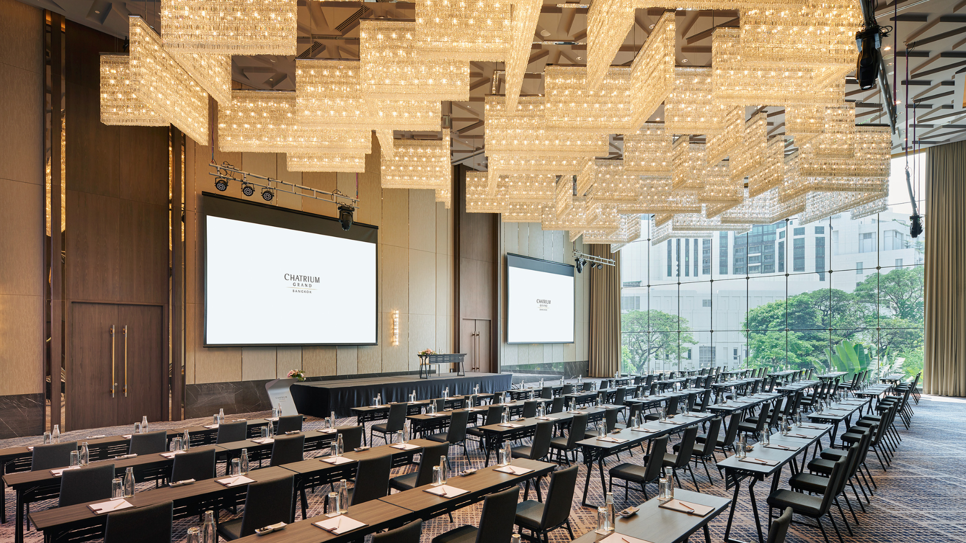 A spacious conference room featuring multiple tables and chairs arranged for a meeting or event.